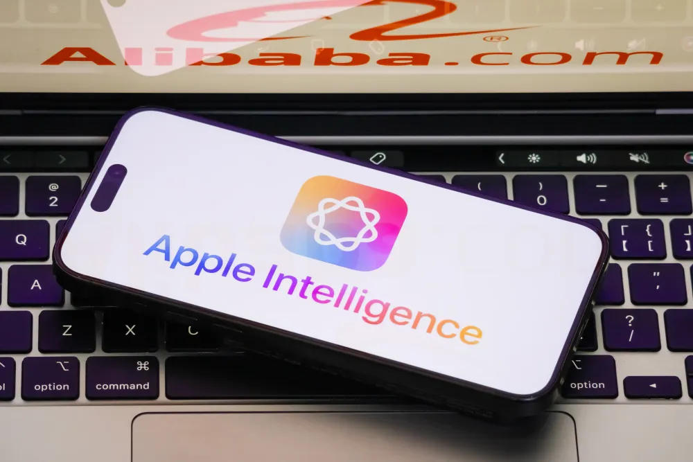 A close-up of a smartphone displaying the Apple Intelligence logo, with the Alibaba logo shown in the backdrop. (Photo by Cheng Xin/Getty Images)