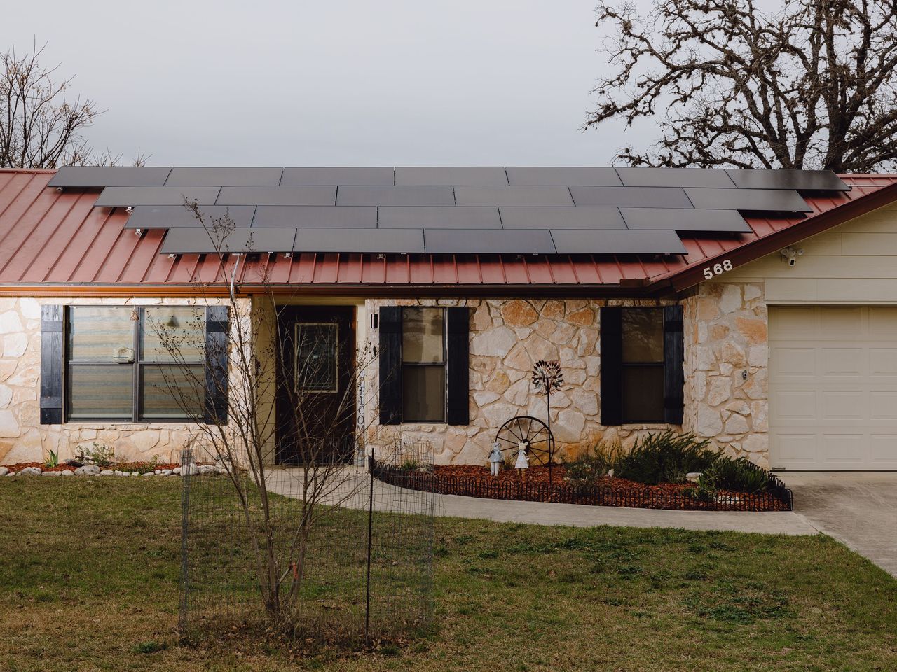 Solar panels on the roof of Tom Cook's home on Fri, Feb 14, 2025, in Bandera, Texas. Power is generated and then stored in Enphase batteries in the detached garage at Cook's home. (Christopher Lee/Houston Chronicle via Getty Images)