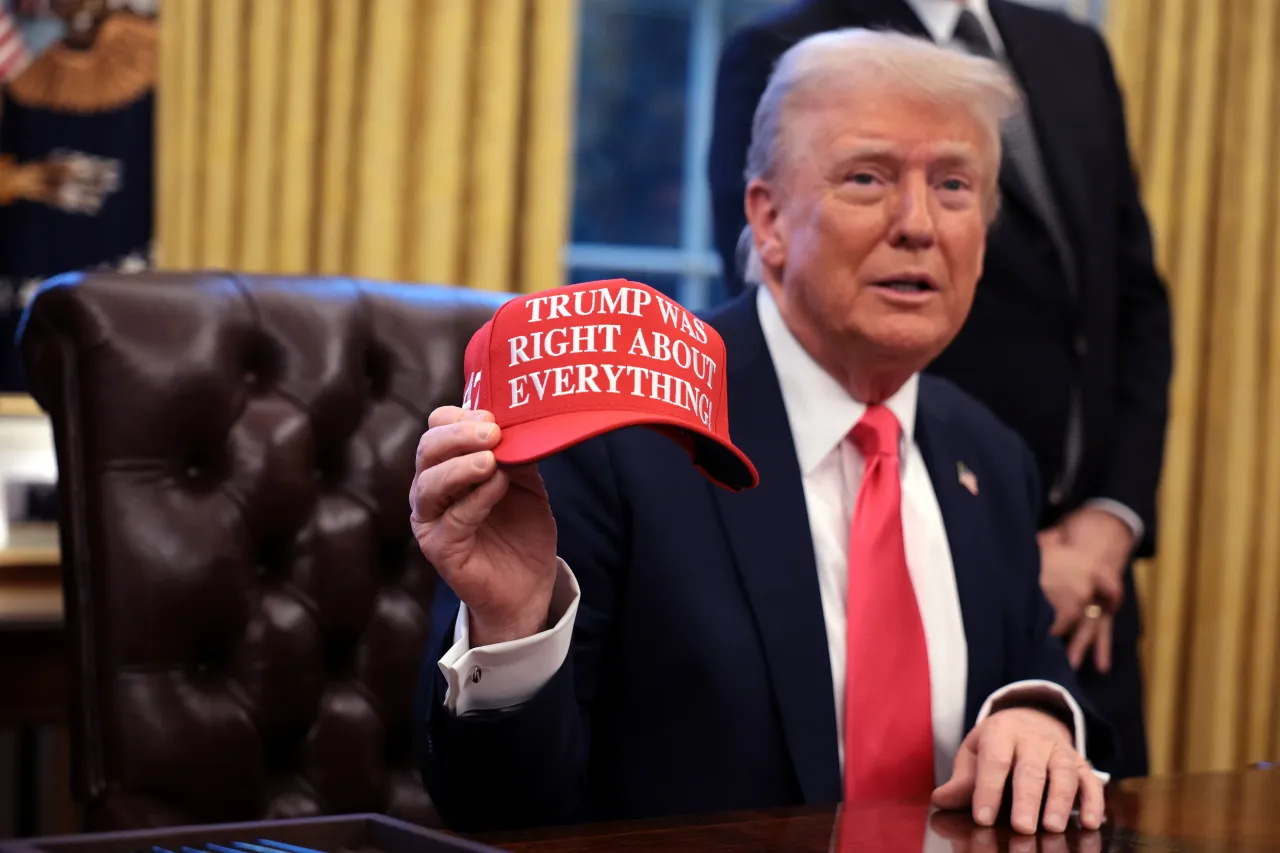 Donald Trump holds up a hat stating "Trump Was Right About Everything" after signing executive orders in the Oval Office at the White House on February 25, 2025. (Photo by Alex Wong/Getty Images)