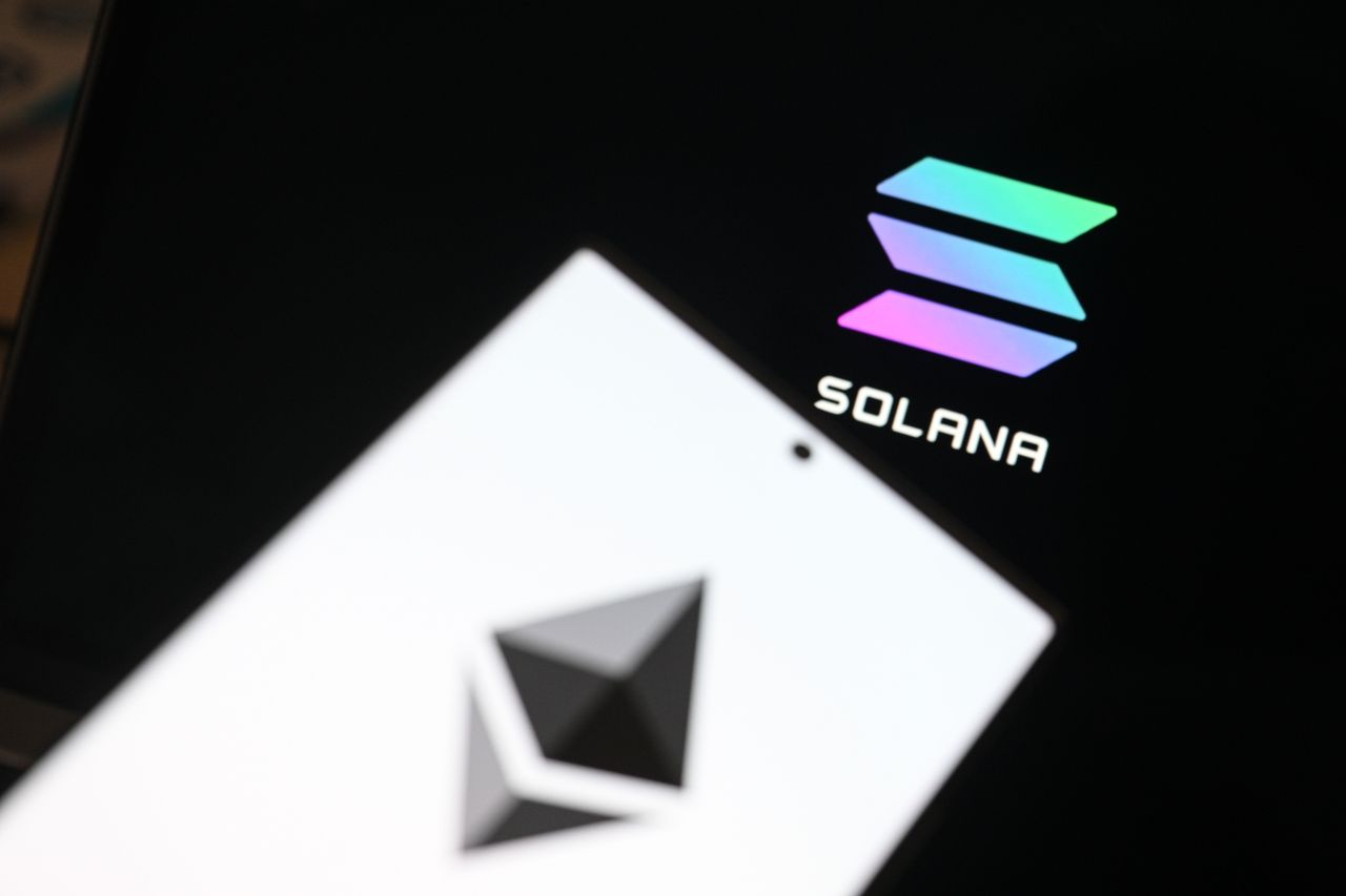 In this photo illustration, the 'Ethereum' logo is displayed on a mobile phone screen in front of a computer screen displaying the 'SolanaI' logo in Ankara, Turkiye on March 07, 2025. (Photo by Harun Ozalp/Anadolu via Getty Images)