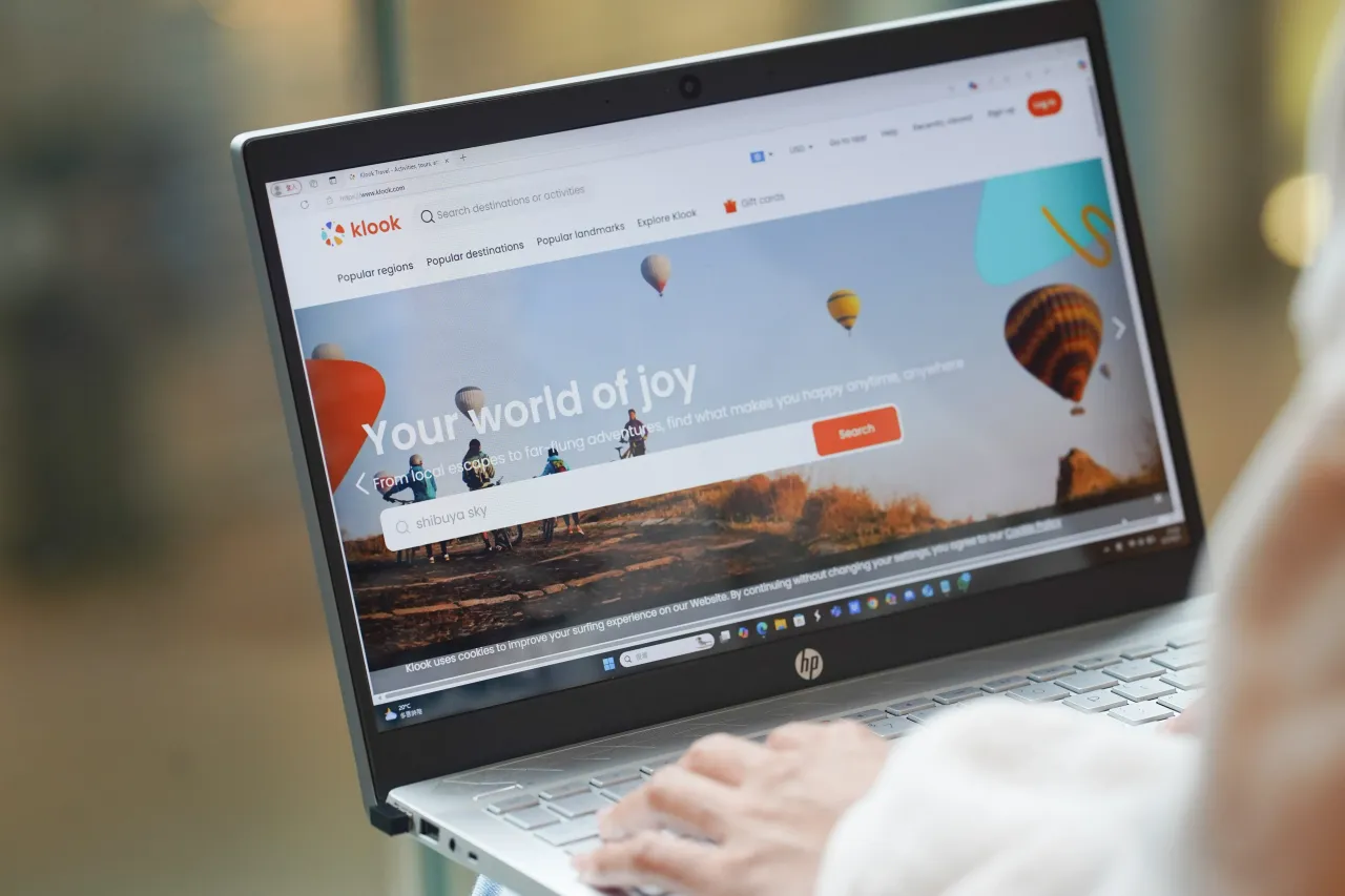 In this photo illustration, A woman browses Klook website on her laptop. (Photo Illustration by Serene Lee/SOPA Images/LightRocket via Getty Images)