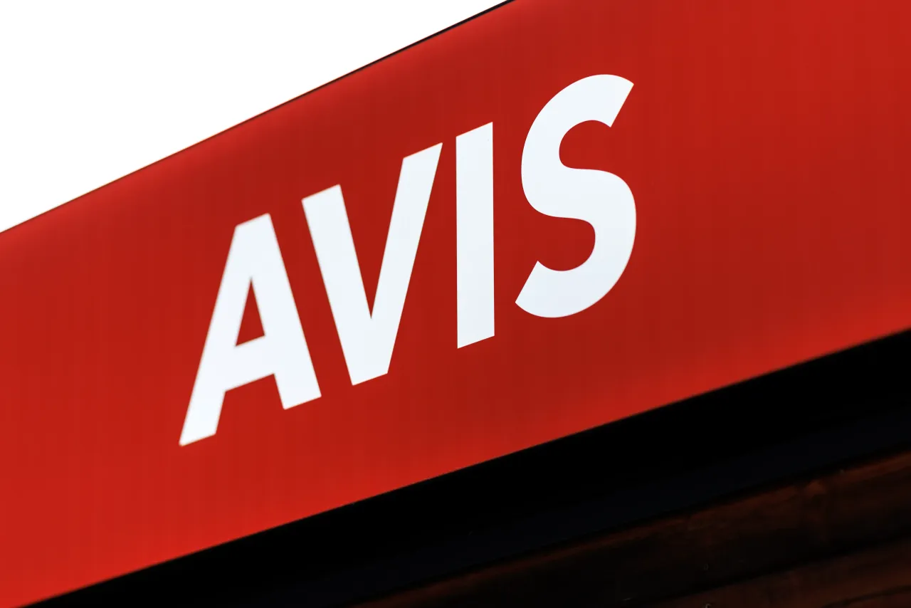 The logo and lettering of Avis Rent a Car can be seen on a sign at a branch (car rental station) of the company in Memmingen (Bavaria). Photo: Matthias Balk/dpa (Photo by Matthias Balk/picture alliance via Getty Images)
