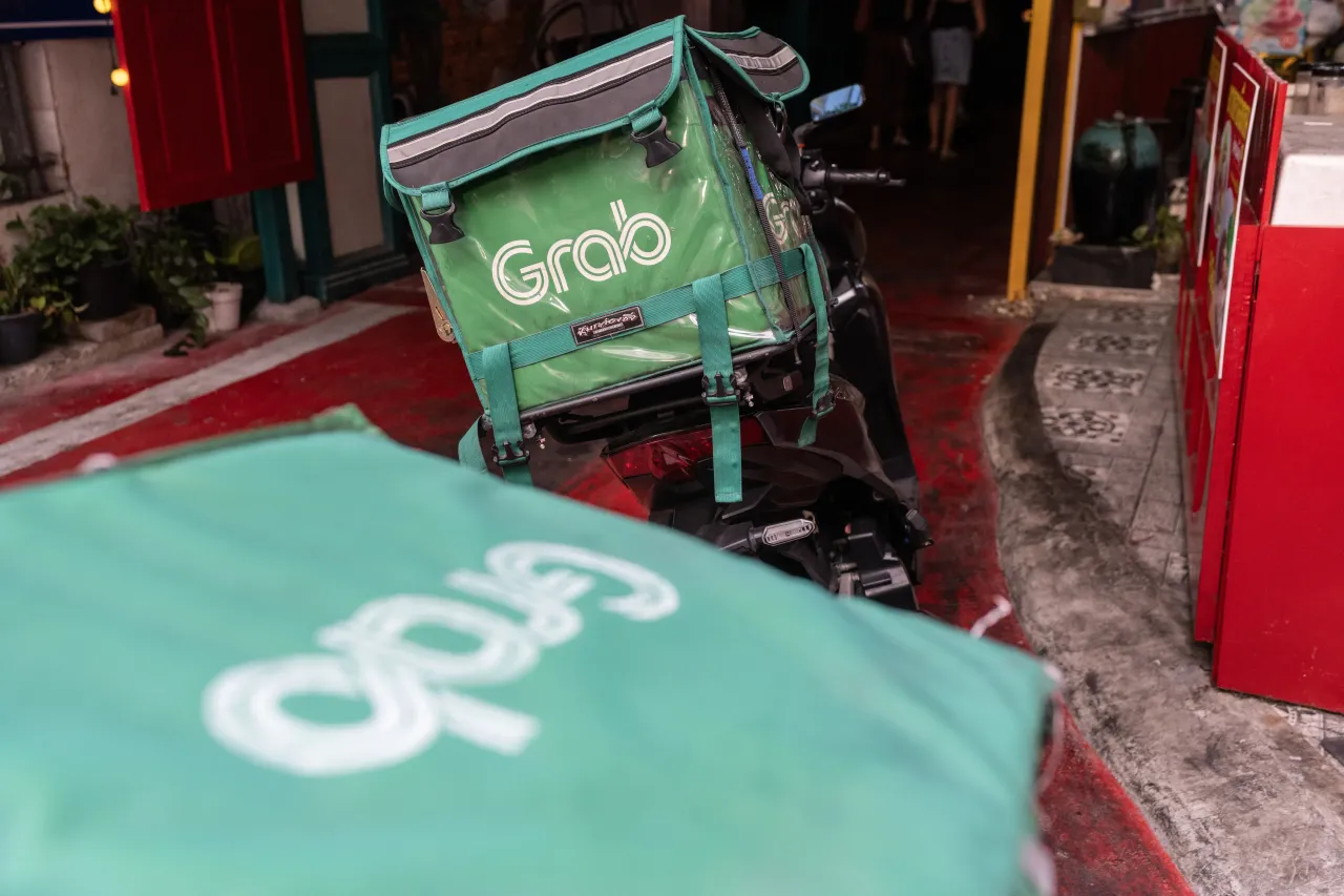 A Grab food delivery rider motorcycle parked in the busy streets. (Photo by John Wreford/SOPA Images/LightRocket via Getty Images)