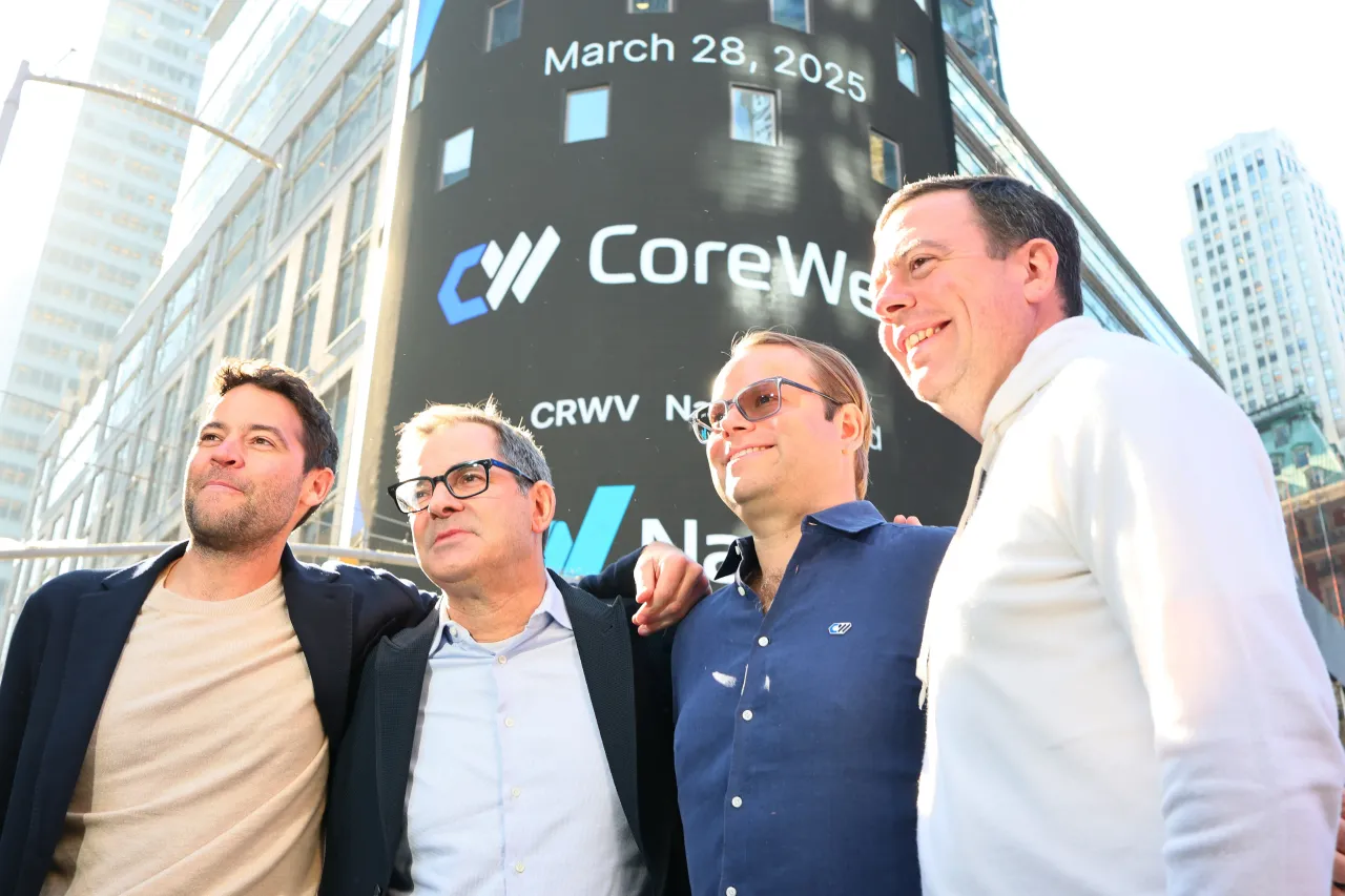 CoreWeave’s Chief Development Officer Brannin McBee, CEO Mike Intrator, CTO Peter Salanki, and Chief Strategy Officer Brian Venturo pose for photos during the company's IPO on March 28, 2025. (Photo by Michael M. Santiago/Getty Images)