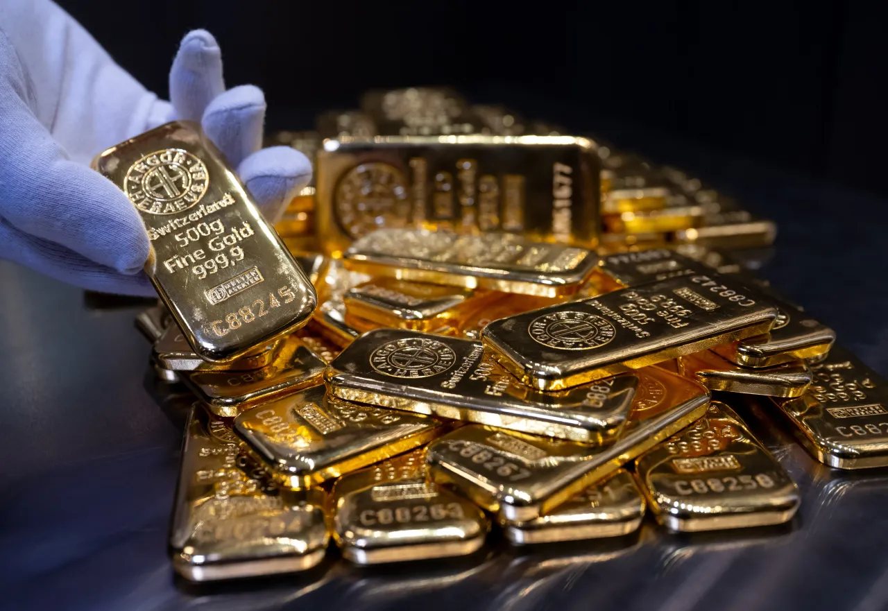 Gold bars of various sizes lie in a safe on a table at the precious metal dealer Pro Aurum. 