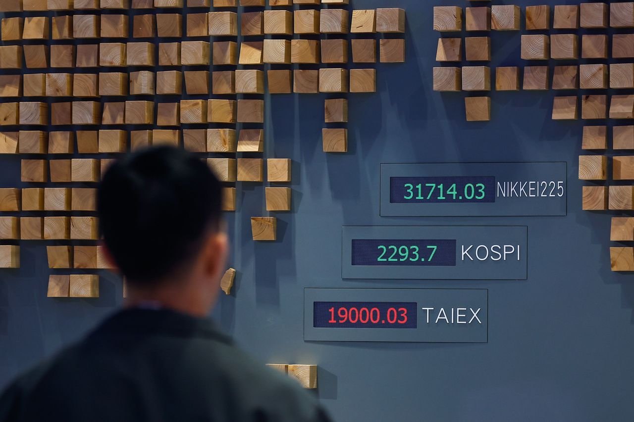 A man looks at digital boards show surging stock shares at the Taiwan Stock Exchange office, following U.S. President Donald Trump's surprise decision to pause the global tariffs, in Taipei, Taiwan, on April 10, 2025. (Photo by Daniel Ceng/Anadolu via Getty Images)