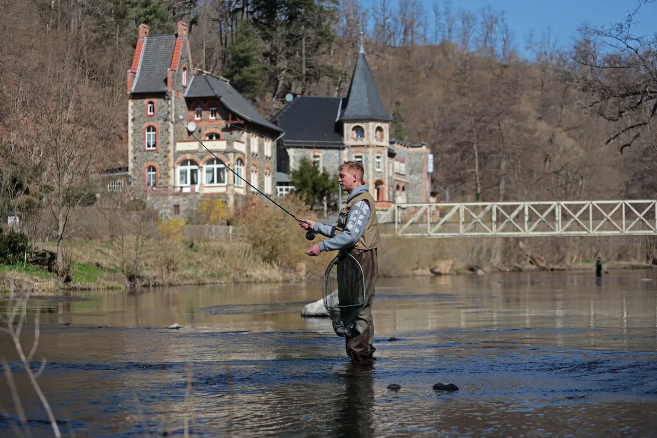A fisherman stands in the Kalte Bode with a fishing rod. (Photo by Matthias Bein/picture alliance via Getty Images)