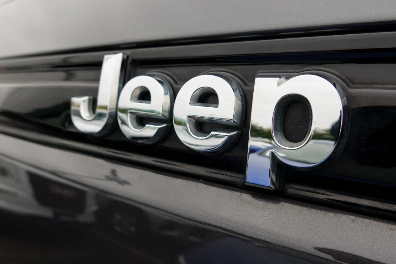 A Jeep logo is displayed on a vehicle for sale at a dealership on April 12, 2025 in San Diego, California. (Photo by Kevin Carter/Getty Images)