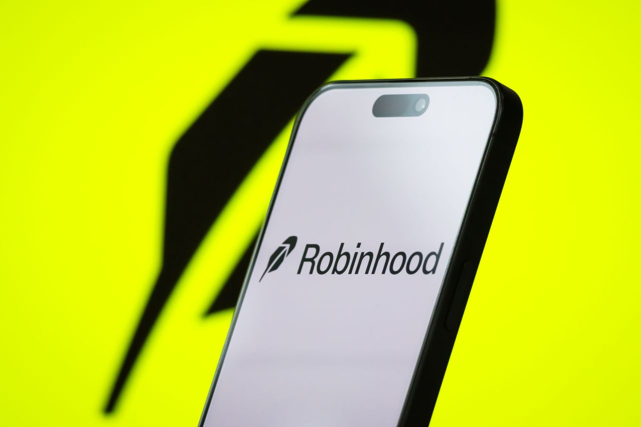 Robinhood is an American financial services company known for its commission-free stock and cryptocurrency trading platform, which has attracted a large base of retail investors, particularly younger users. (Photo illustration by Cheng Xin/Getty Images)