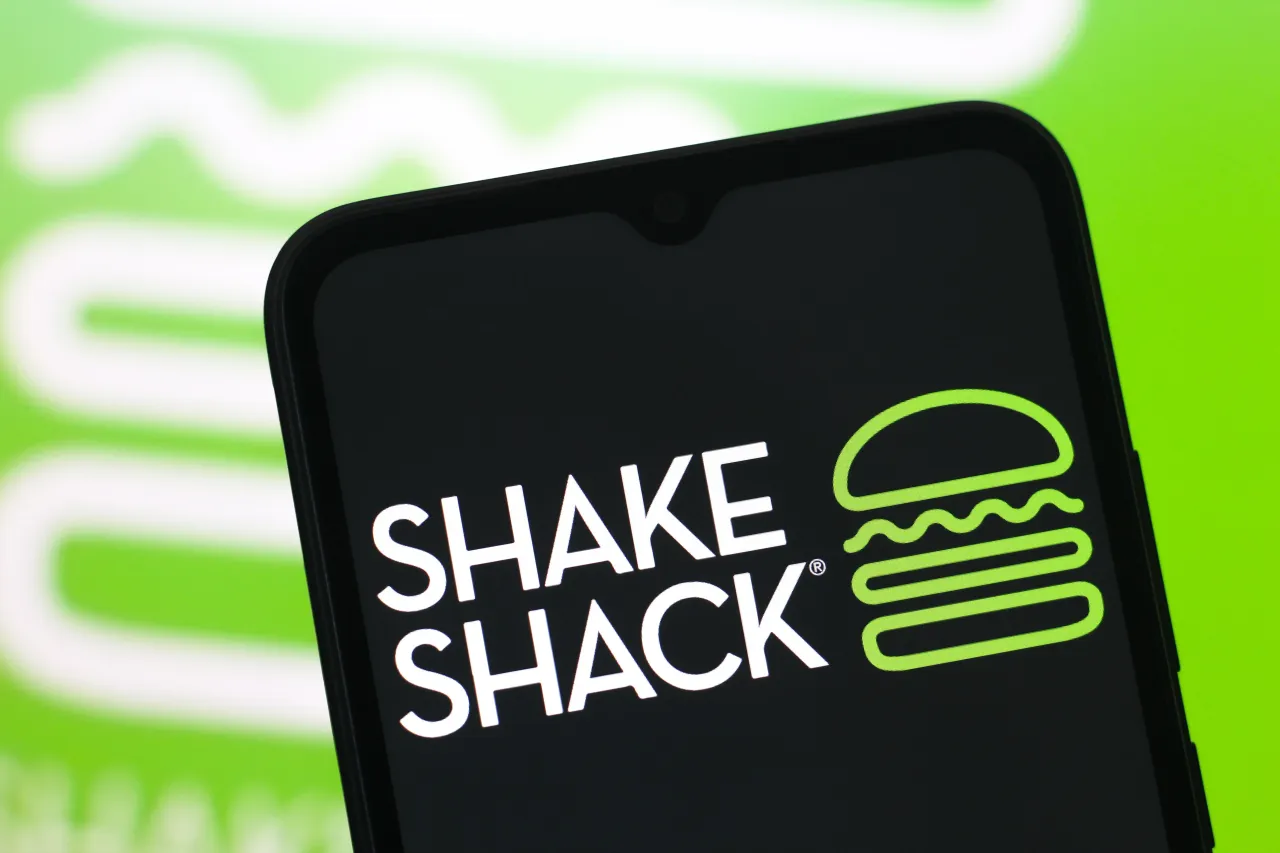 In this photo illustration, the Shake Shack logo is seen displayed on a smartphone screen. (Photo Illustration by Thomas Fuller/SOPA Images/LightRocket via Getty Images)