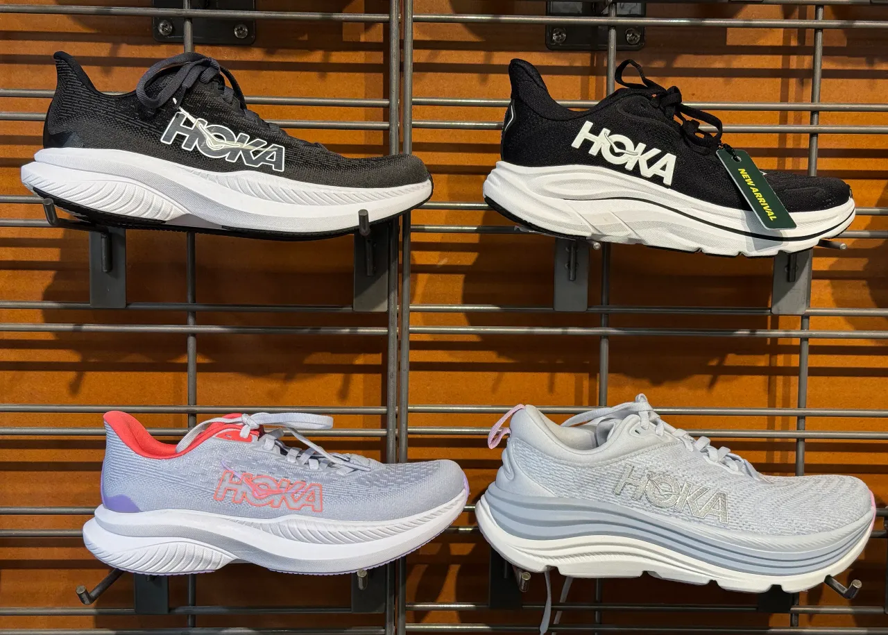 Hoka shoes are displayed on a shelf at an REI store on May 23, 2025 in Corte Madera, California. (Photo by Justin Sullivan/Getty Images)
