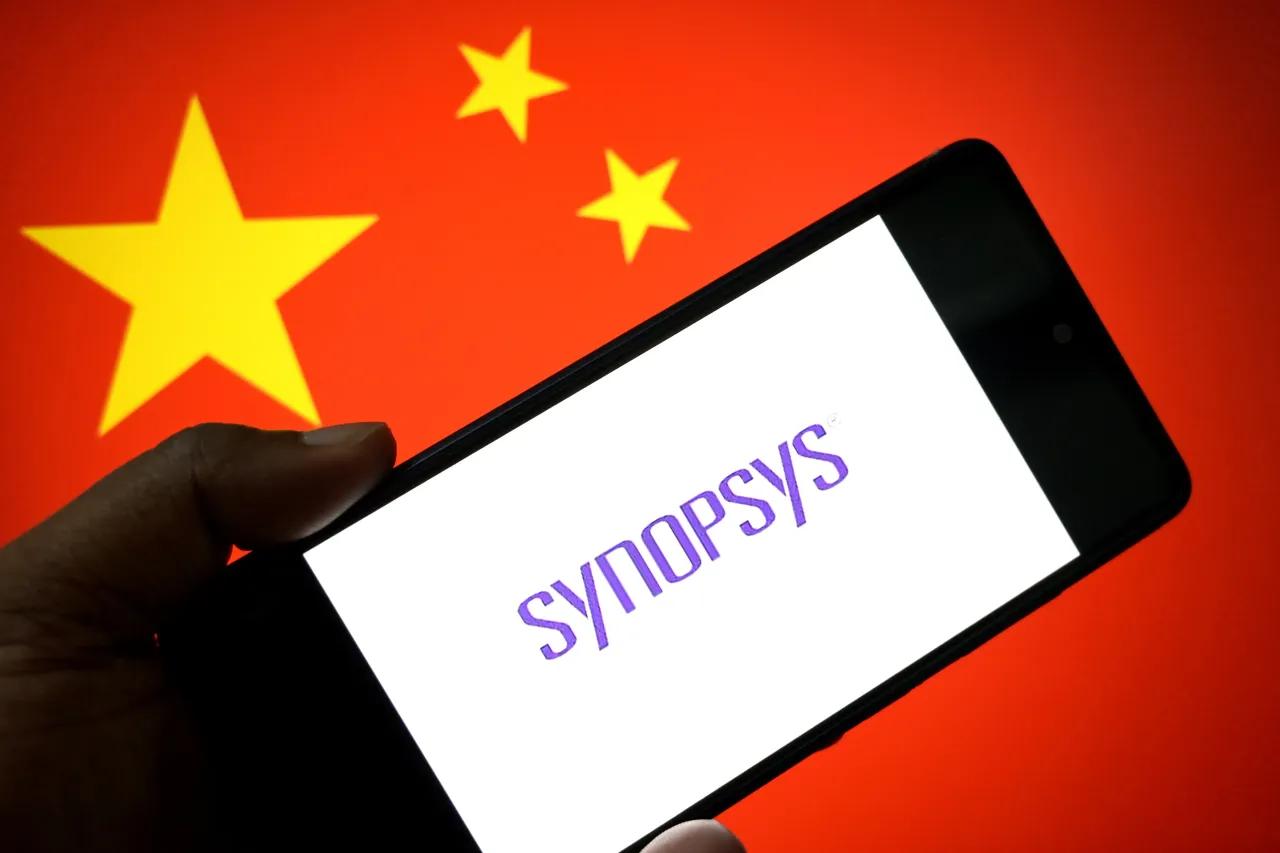 In this photo illustration, a Synopsys logo is seen displayed on a smartphone with the flag of China in the background. 