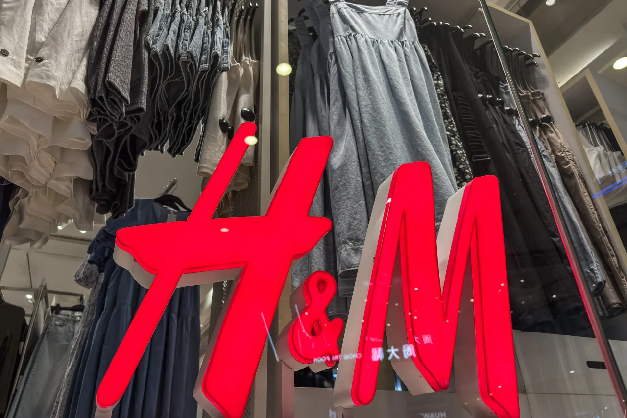 A close-up view of the illuminated red H&M logo at a retail store in Chongqing, China on May 31, 2025 in. (Photo Illustration by Justin Sullivan/Getty Images)