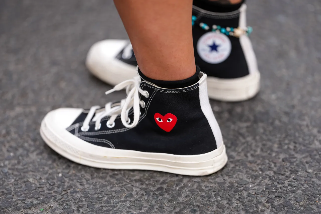 A guest wears high-top Converse x Comme des Garçons sneakers at the Paris Fashion Week on June 25, 2025. (Photo by Edward Berthelot/Getty Images)