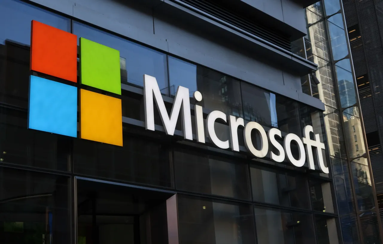 A corporate logo for Microsoft hangs above the door to their office building on 8th Avenue on June 24, 2025, in New York City. 