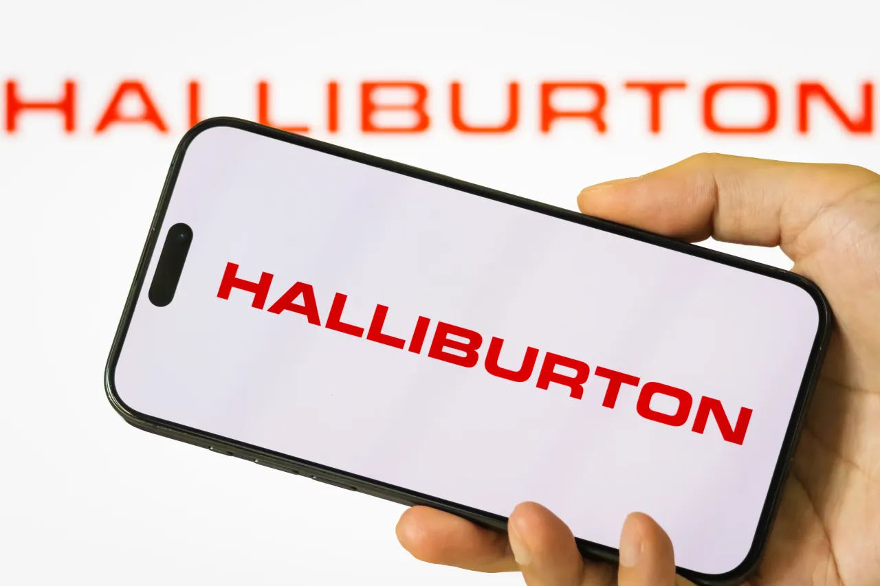  In this photo illustration, a person holds a smartphone displaying the logo of Halliburton Company. 
