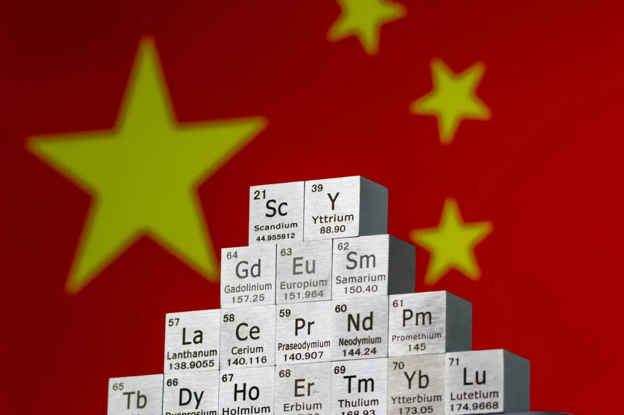  In this photo illustration, metal cubes representing rare earth elements stacked in a stepped formation in front of the national flag of China.