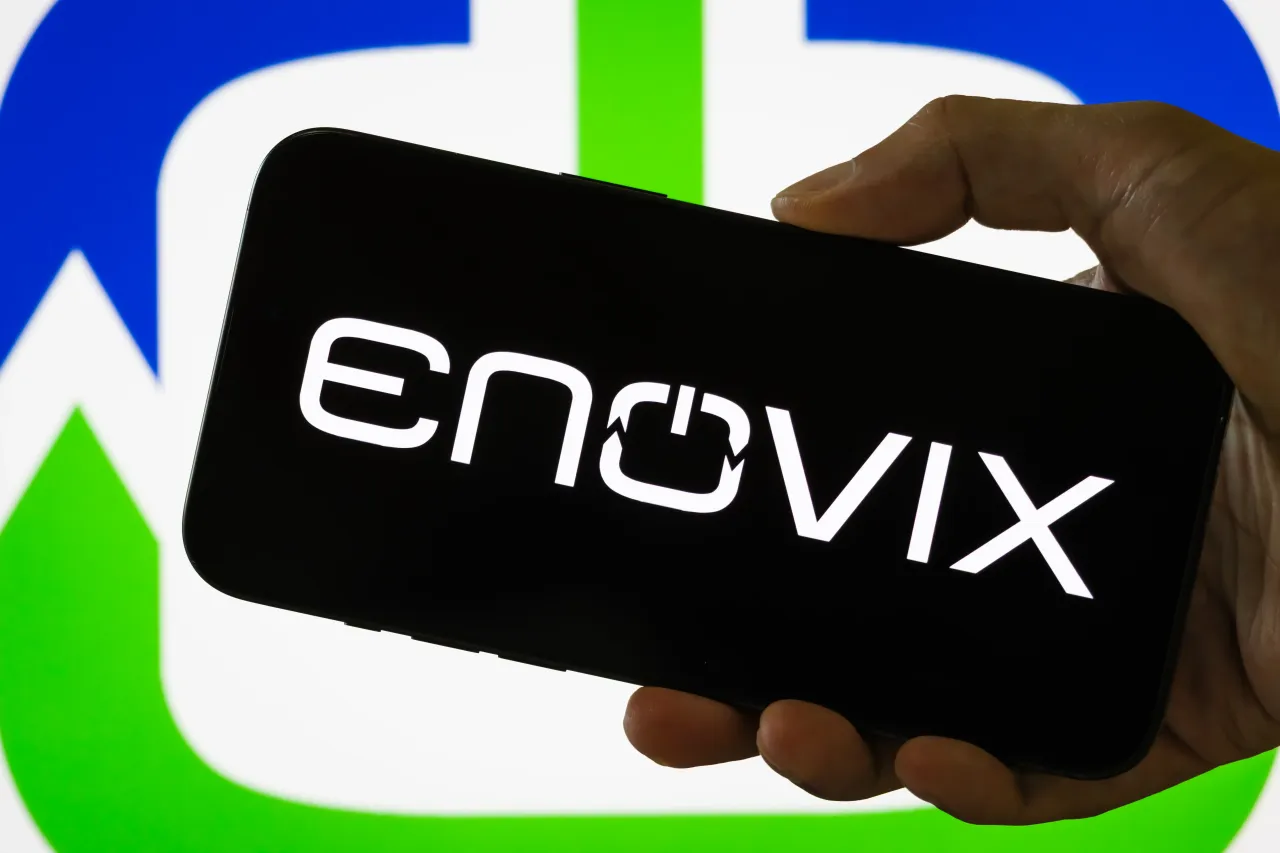  In this photo illustration, a person holds a smartphone displaying the logo of Enovix Corporation.
