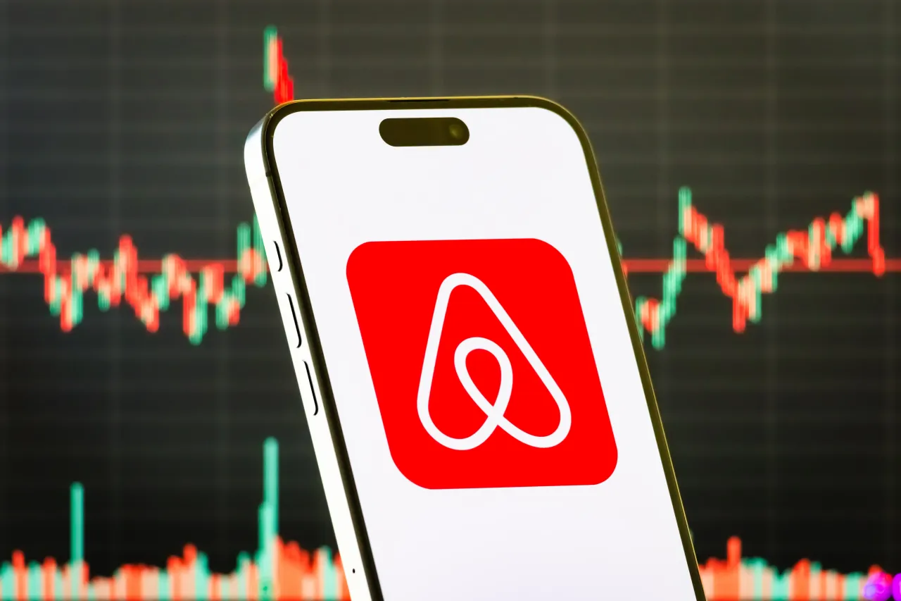 A smartphone displays the logo of Airbnb Inc. (Photo illustration by Cheng Xin/Getty Images)