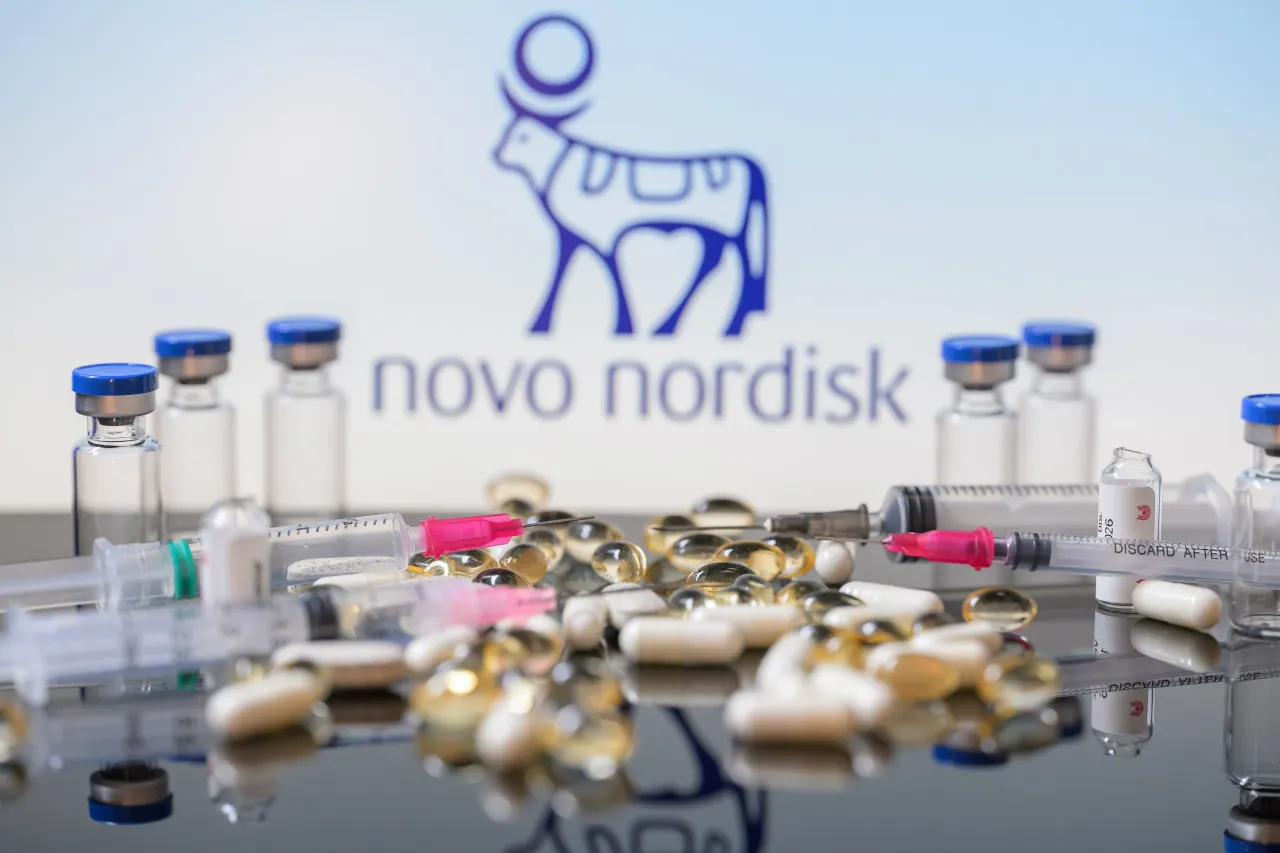The Novo Nordisk logo is seen with tablets, capsules, and syringes in this photo illustration in Brussels, Belgium, on August 9, 2025.