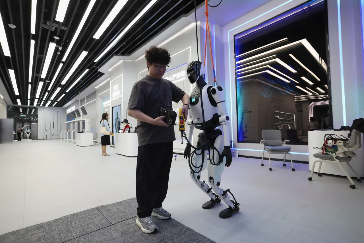 A worker debugging a humanoid robot at world's first embodied intelligent robot 4S store on August 06, 2025 in Beijing, China. (Photo by Lintao Zhang/Getty Images)