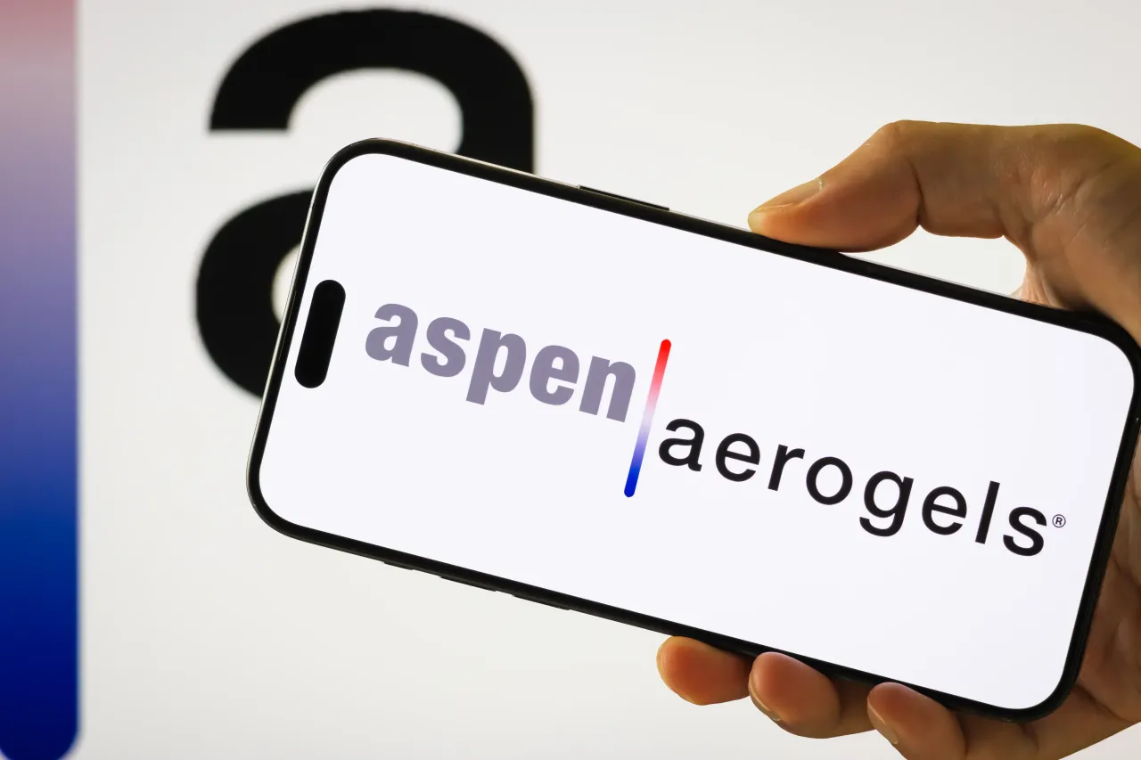In this photo illustration, a person holds a smartphone displaying the logo of Aspen Aerogels Inc. (Photo illustration by Cheng Xin/Getty Images)