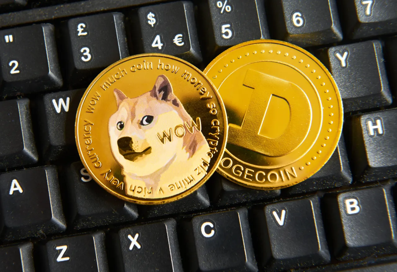 A Dogecoin coin on a keyboard.