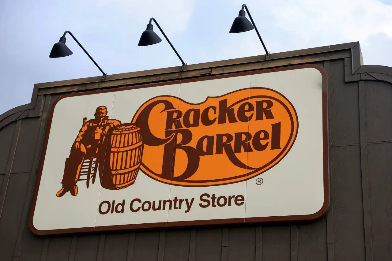 A Cracker Barrel sign featuring the old logo hangs outside of a restaurant in Florida City, Florida.