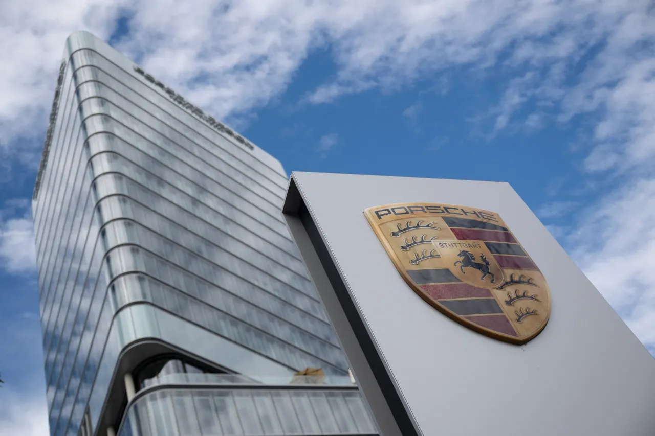 The Porsche logo can be seen in front of the Porsche Design Tower. Photo: Marijan Murat/dpa (Photo by Marijan Murat/picture alliance via Getty Images)