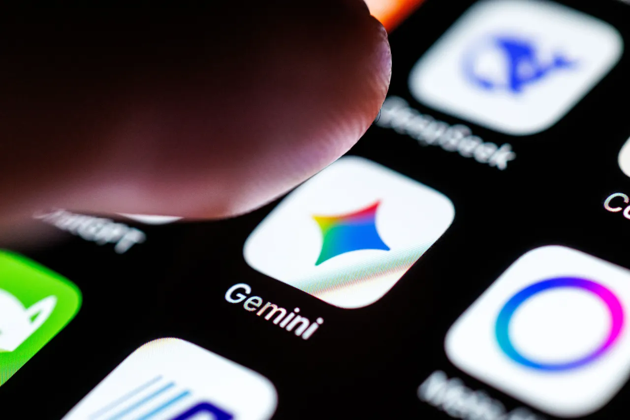 The Gemini app on a smartphone screen, as an index finger approaches the app's icon. (Photo by Matthias Balk/picture alliance via Getty Images)