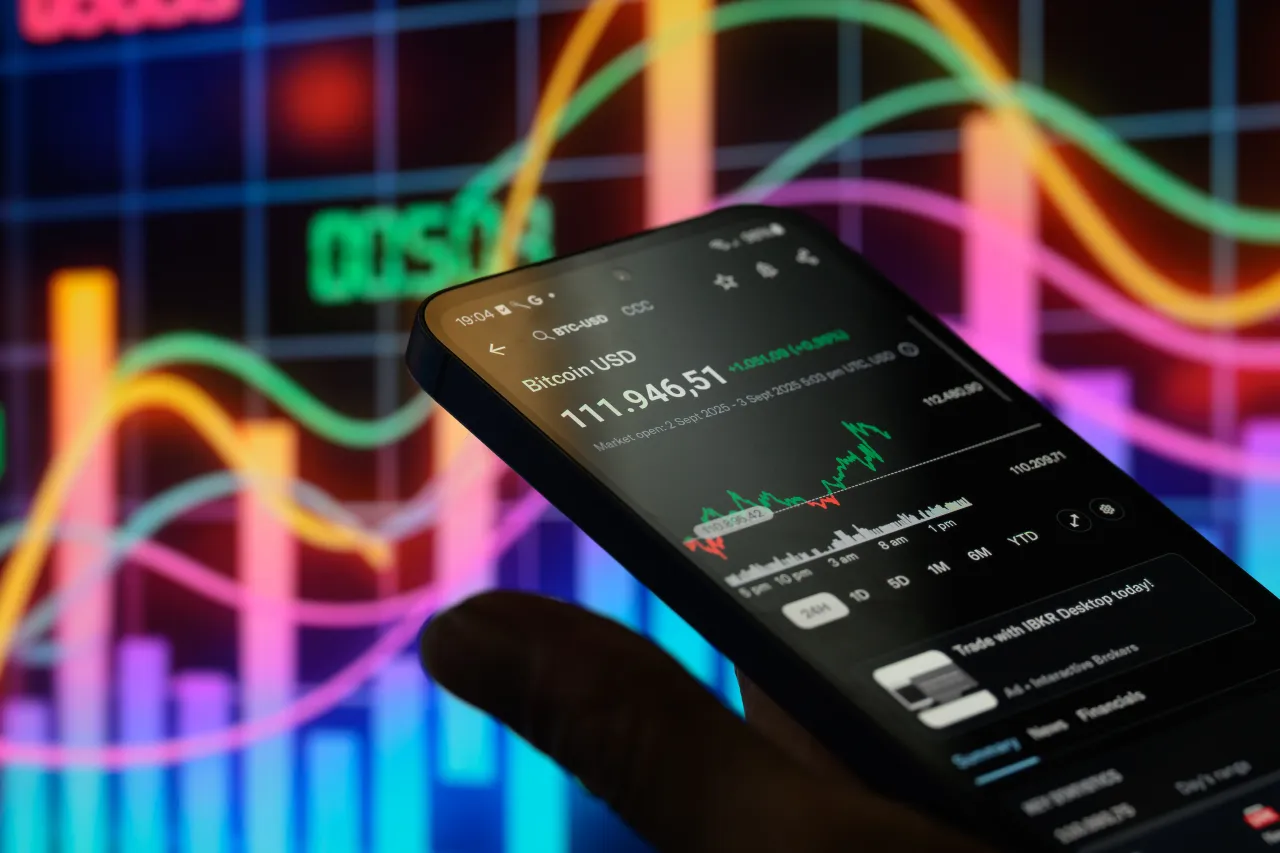 The Bitcoin stock is displayed on a mobile phone with a stock graph seen in the background in this photo illustration in Brussels, Belgium, on September 3, 2025. 