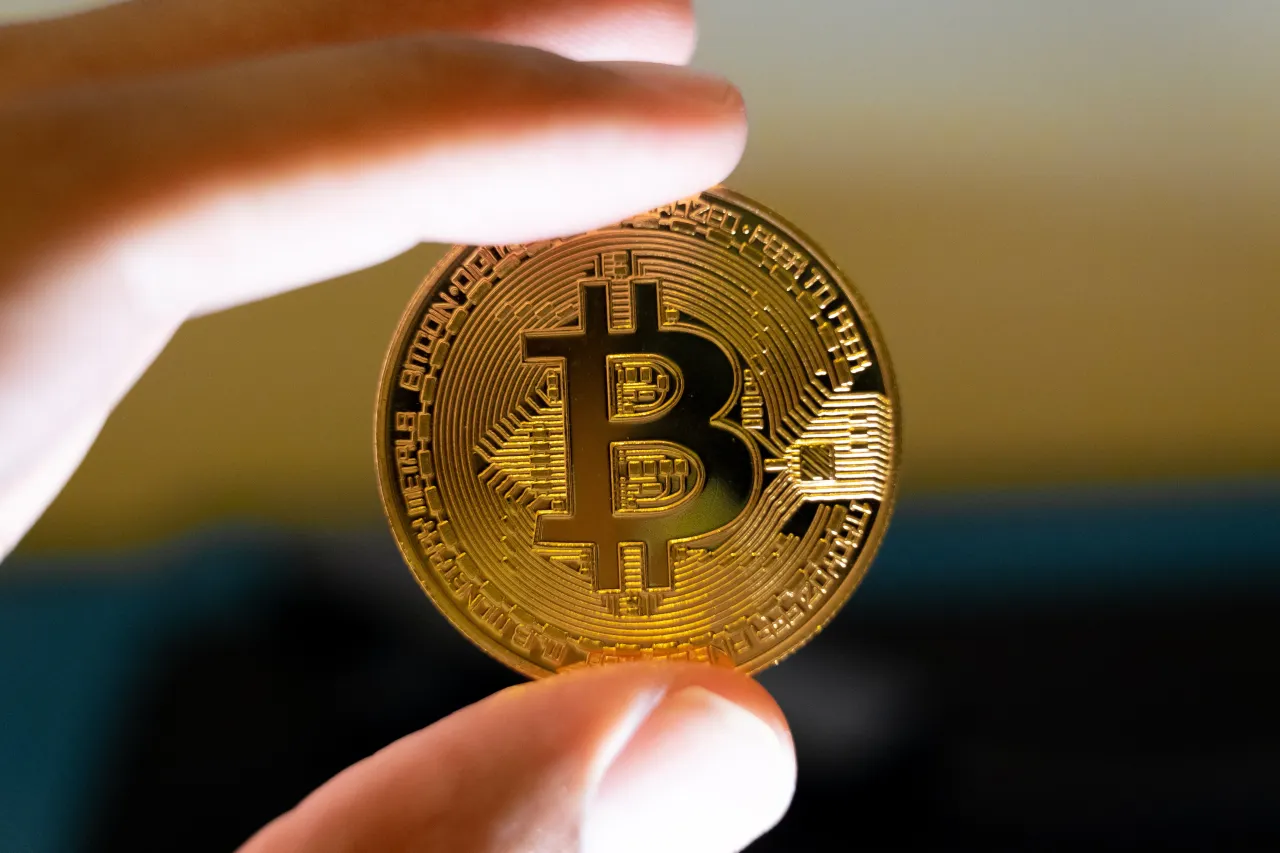 A macro shot of a man's hand holding a Bitcoin representation is seen in Athens, Greece, on September 4, 2025. (Photo by Nikolas Kokovlis/NurPhoto via Getty Images)