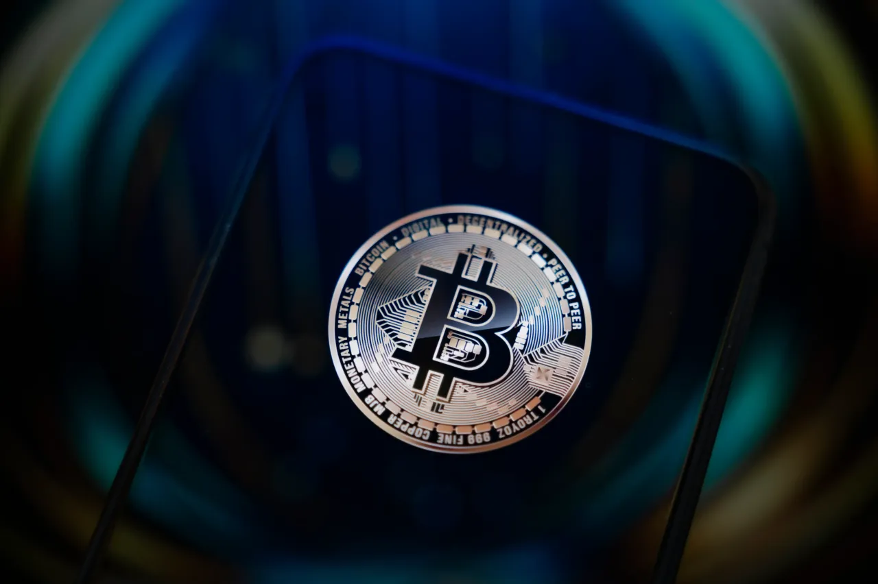 This photo shows a smartphone screen displaying the logo of a Bitcoin cryptocurrency token on Sept. 12, 2025.