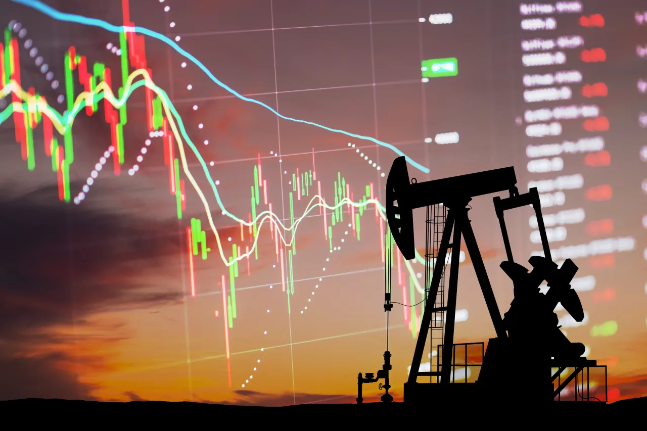 Oil pump on the background of stock charts - stock photo (Source: Getty Images)