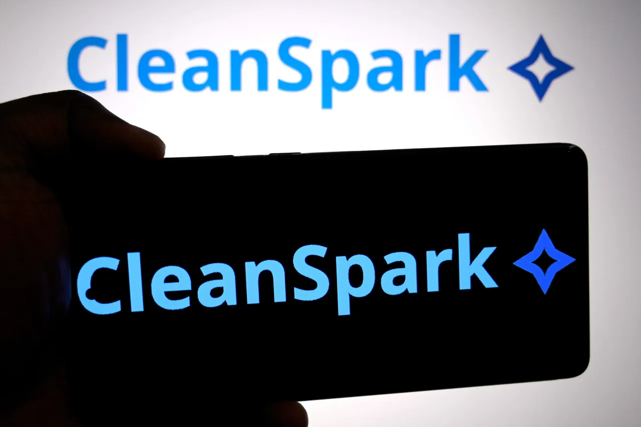 In this photo illustration, the CleanSpark logo is seen displayed on a smartphone and in the background. (Photo Illustration by Avishek Das/SOPA Images/LightRocket via Getty Images)