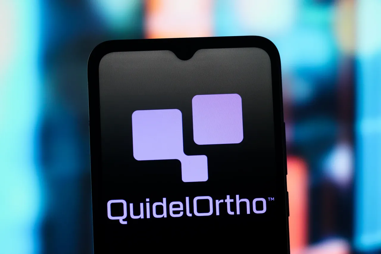 In this photo illustration, the QuidelOrtho Corporation (Quidel Ortho) logo is seen displayed on a smartphone screen. (Photo Illustration by Thomas Fuller/SOPA Images/LightRocket via Getty Images)