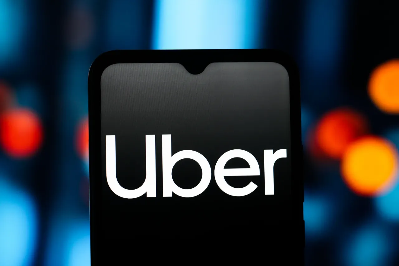 In this photo illustration, the Uber logo is seen displayed on a smartphone screen. (Photo Illustration by Thomas Fuller/SOPA Images/LightRocket via Getty Images)