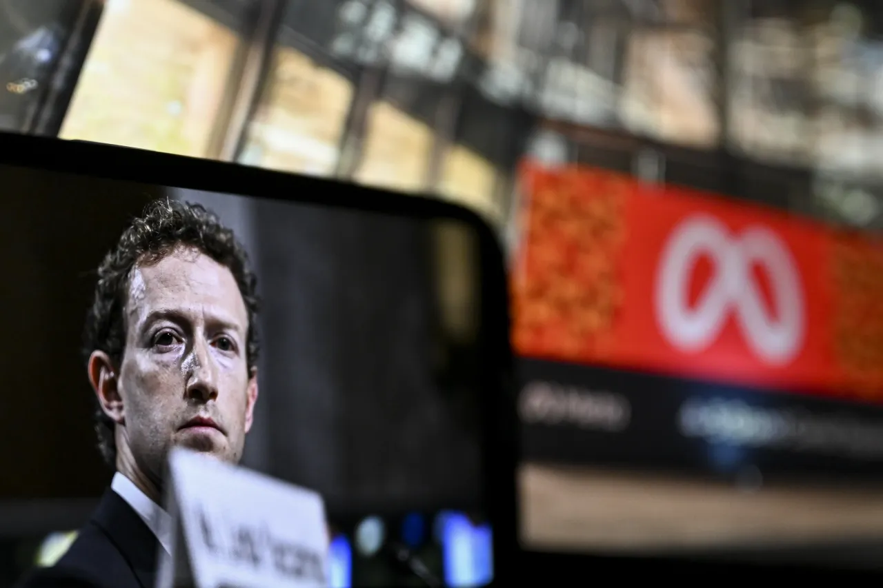 A digital screen displays Meta logo and a mobile phone screen displays founder of Meta Mark Zuckerberg. (Photo by Arda Kucukkaya/Anadolu via Getty Images)
