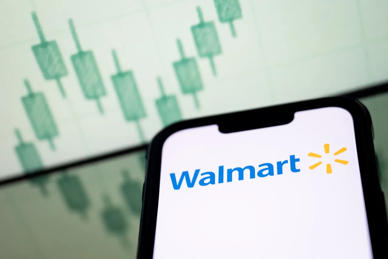 A Walmart logo seen displayed on a smartphone screen, with a stock chart in the background. The retail chain is reporting Q3 results on Thursday during the premarket hours.(Photo Illustration by Mateusz Slodkowski/SOPA Images/LightRocket via Getty Images)