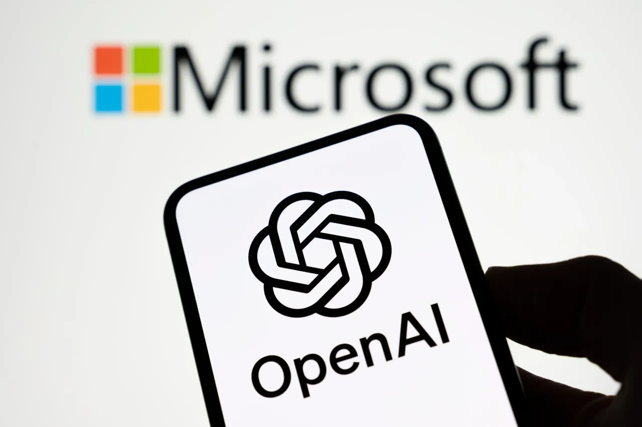 The OpenAI logo appears on a smartphone screen with the Microsoft logo in the background. 