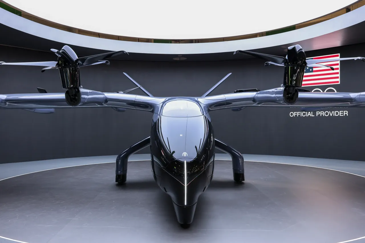 Visitors take photographs of the Archer Midnight electric vertical takeoff and landing aircraft eVTOL.