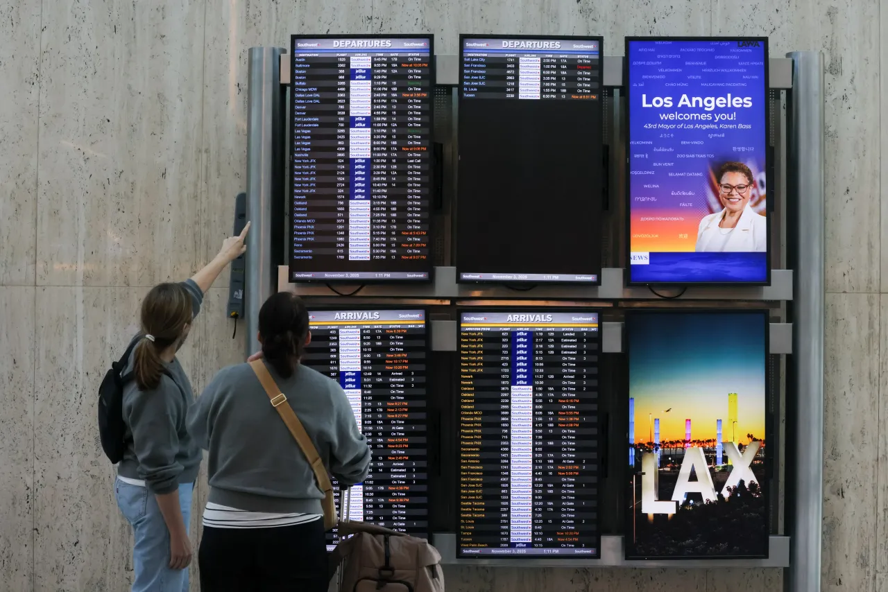 Travelers look at the flight information display system at Los Angeles International Airport on Monday, Nov. 3, 2025 in Los Angeles, CA. (Juliana Yamada / Los Angeles Times via Getty Images)