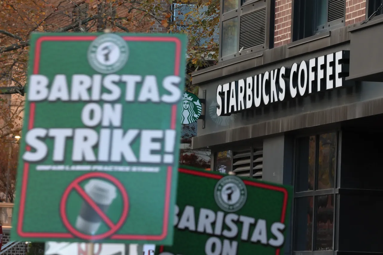 Starbucks workers walk a picket line as they go on strike outside a Starbucks store in Brooklyn on November 13, 2025. (Photo by Michael M. Santiago/Getty Images)