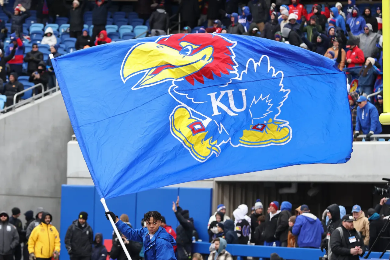 A flag with Kansas Jayhawks logo flies during a Big 12 football game between the Utah Utes and Kansas Jayhawks on November 28, 2025 at David Booth Kansas Memorial Stadium in Lawrence, KS. (Photo by Scott Winters/Icon Sportswire via Getty Images)