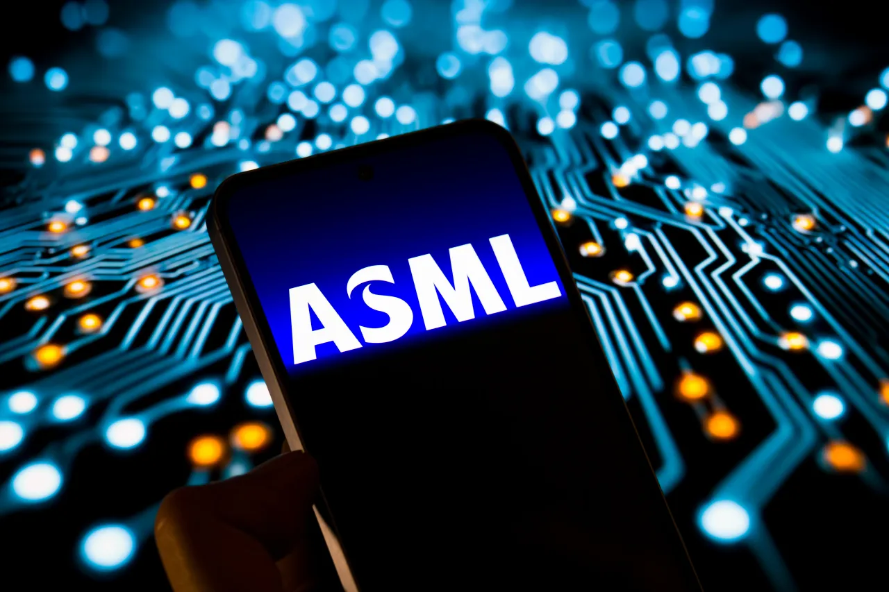 The ASML Holding logo is displayed on a mobile phone with a visual digital background. (Photo Illustration by Jonathan Raa/NurPhoto via Getty Images)
