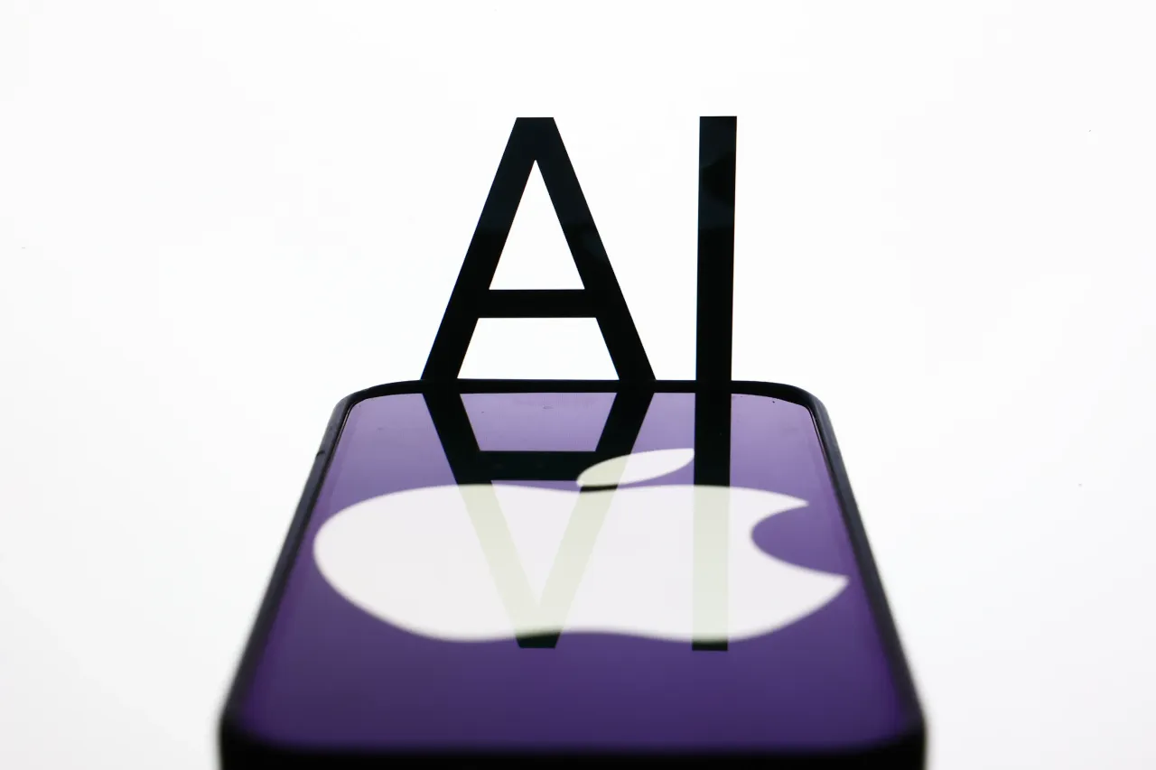 AI sign displayed on a screen and Apple logo displayed on a phone screen. (Photo by Jakub Porzycki/NurPhoto via Getty Images)