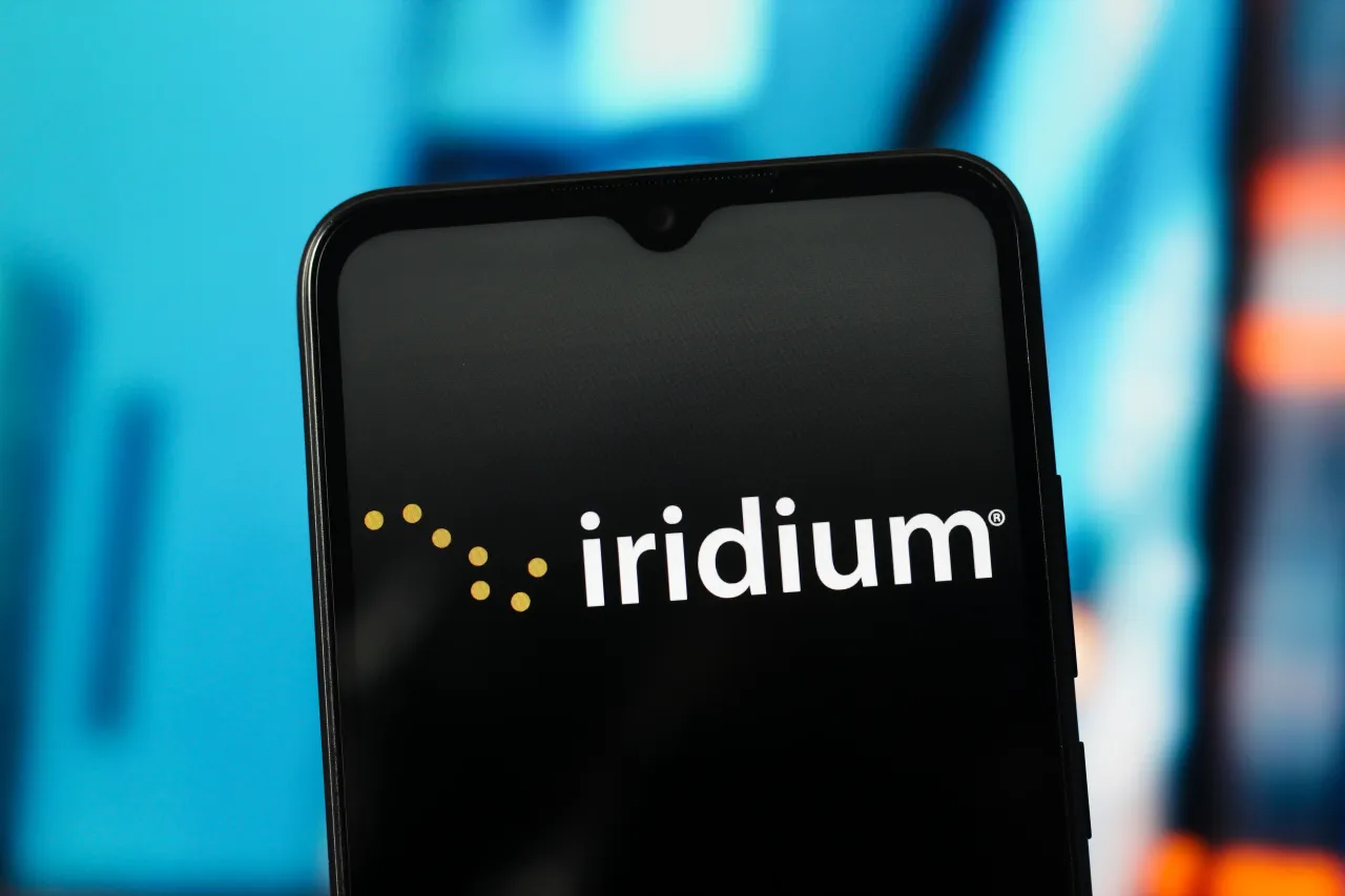 In this photo illustration, the Iridium Communications logo is seen displayed on a smartphone screen.