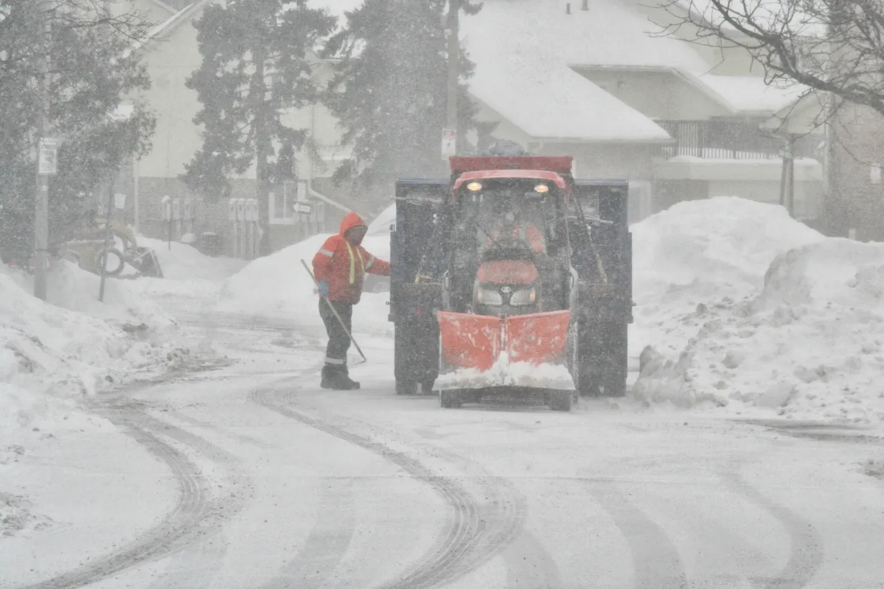 A city worker prepares a snowplow as snow falls in Toronto, Ontario, Canada, on January 19, 2026.