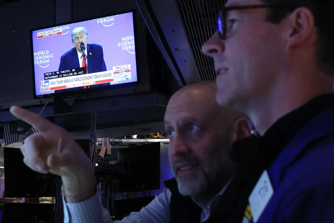 U.S. President Donald Trump is seen speaking on a television as traders work on the floor of the New York Stock Exchange during morning trading on January 21, 2026 in New York City. (Photo by Michael M. Santiago/Getty Images)