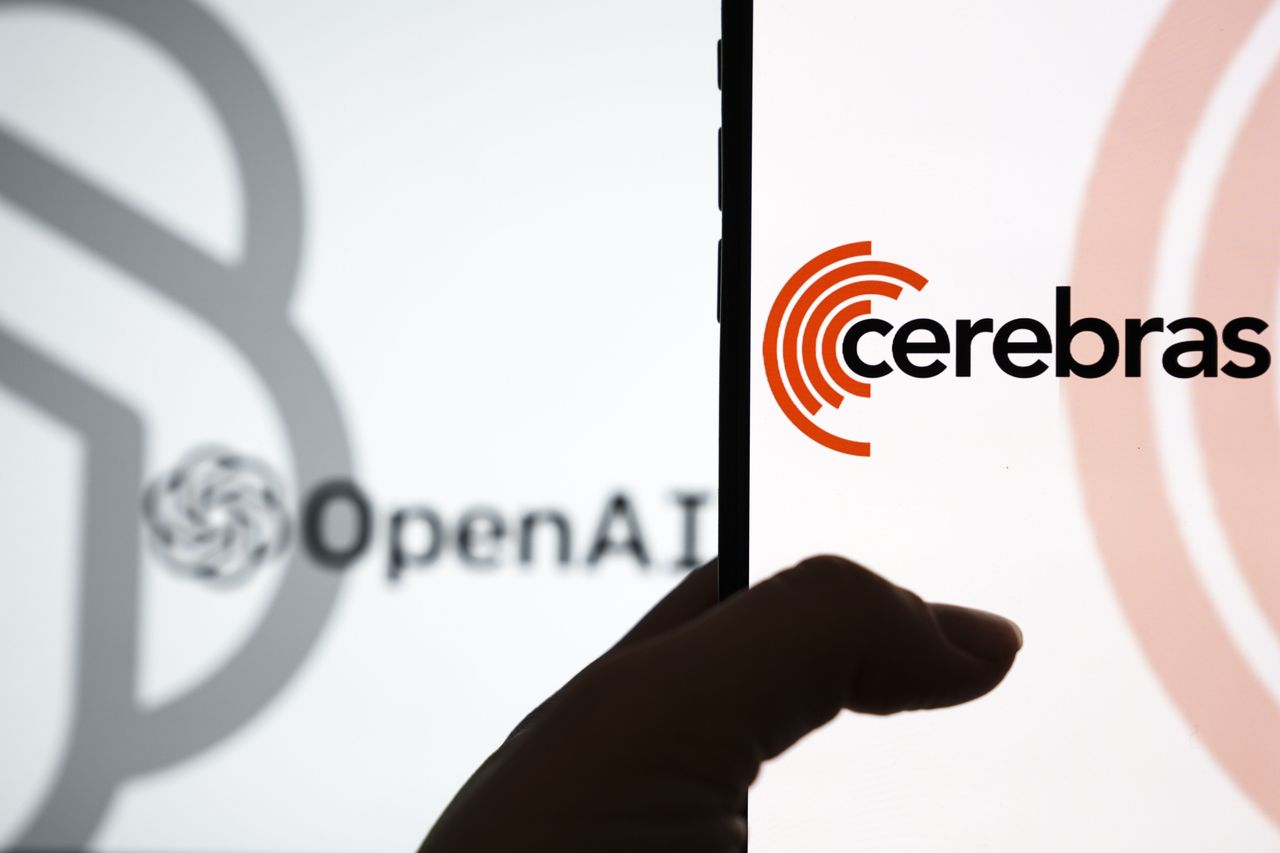 The logo of OpenAI is displayed on a computer screen with the logo of Cerebras is displayed on a mobile phone screen on the front. (Photo by Dilara Irem Sancar/Anadolu via Getty Images)